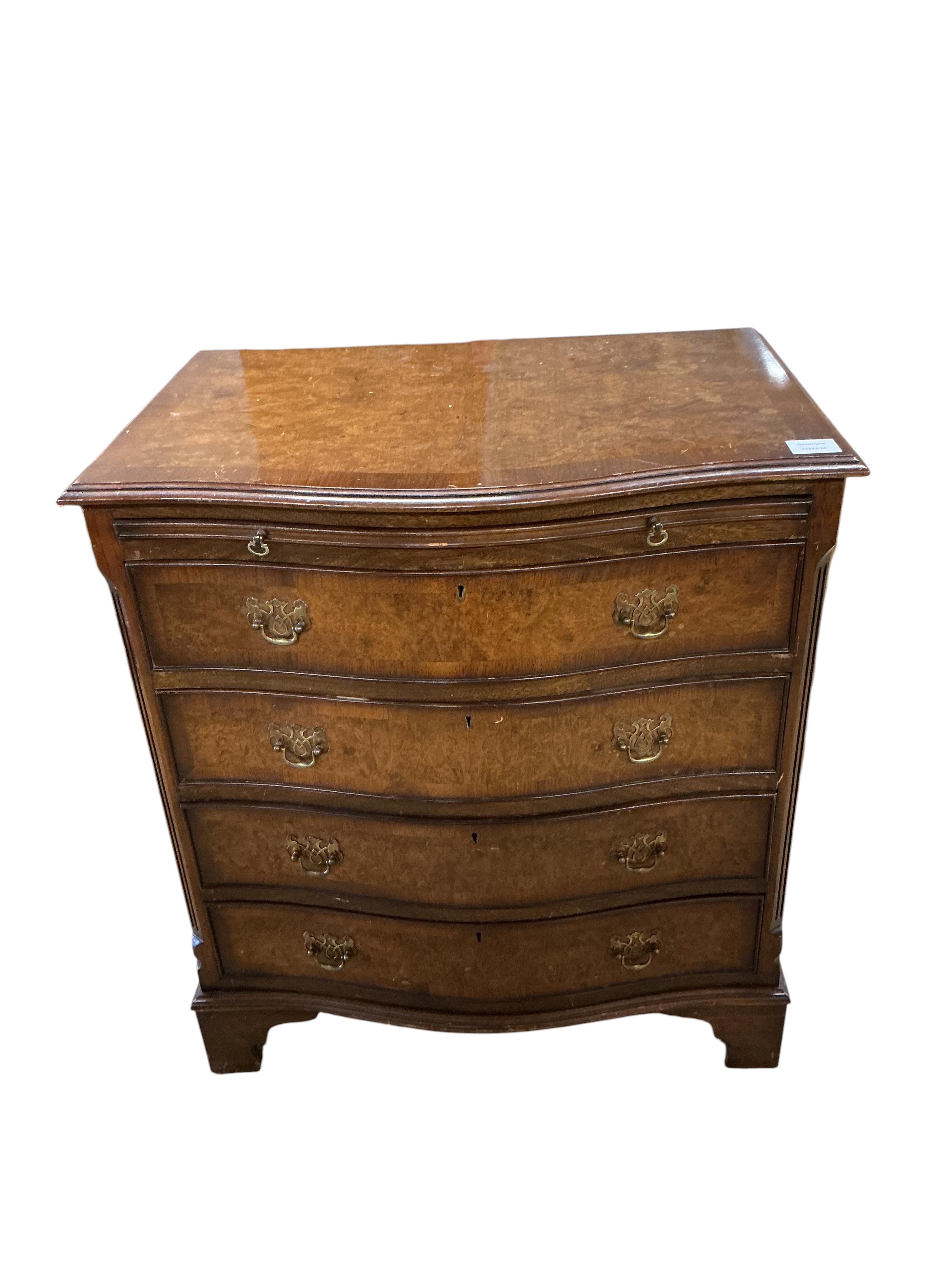 A reproduction George I style walnut serpentine four drawer chest, with brushing slide, width 70cm, depth 48cm, height 77cm